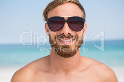 Close up portrait of shirtless man wearing sunglasses