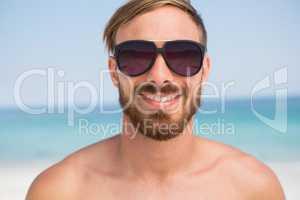 Close up portrait of shirtless man wearing sunglasses