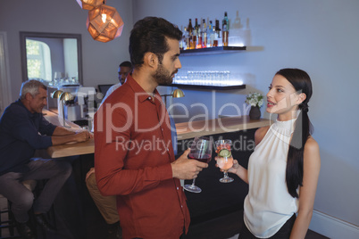 Couple interacting with each other while having drink