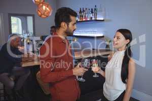 Couple interacting with each other while having drink