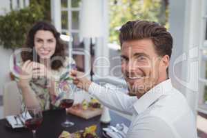 Handsome man offering engagement ring to woman