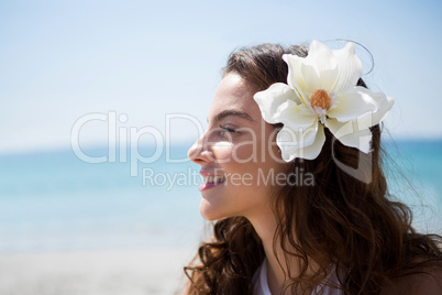 Side view of woman wearing flower