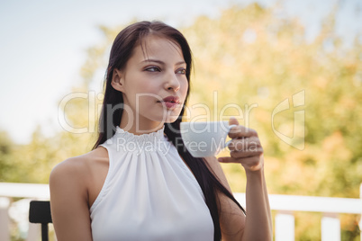 Thoughtful young woman having coffee