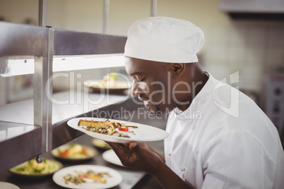 Chef smelling food in commercial kitchen