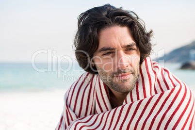 Close up of thoughtful man wrapped in shawl