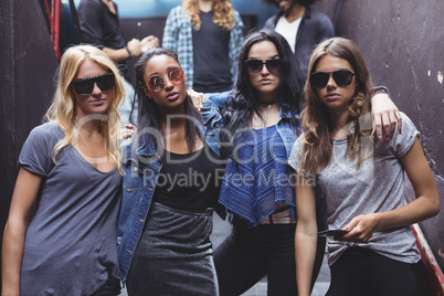 Portrait of female friends wearing sunglasses while staning together