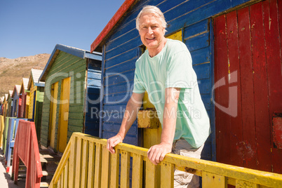 Portrait of man standing at beach hut