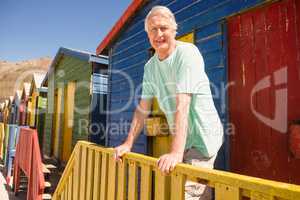 Portrait of man standing at beach hut