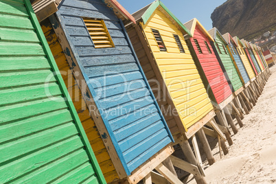 Close up of multi colored huts on sand