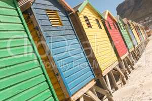 Close up of multi colored huts on sand