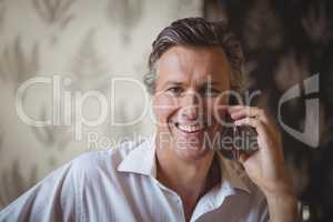 Portrait of mature man talking on mobile phone