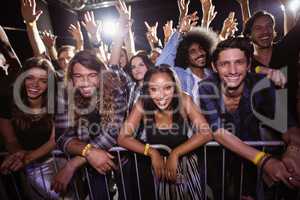 Portrait of friends enjoying at music festival