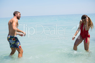 Playful couple enjoying in sea