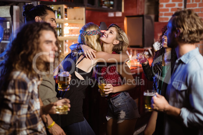 Female friends embracing at club