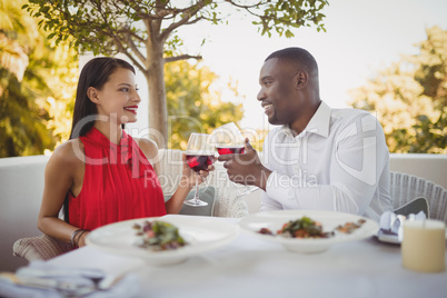 Romantic couple toasting their wine glasses