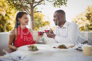 Romantic couple toasting their wine glasses