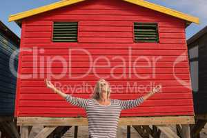 Woman standing against red hut