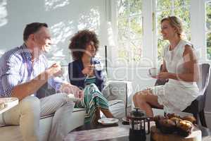 Friends interacting while having coffee