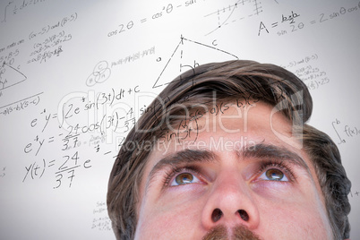 Composite image of close up view of man looking up