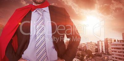 Composite image of happy businessman wearing cape and eye mask