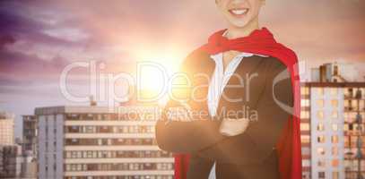 Composite image of portrait of confident woman wearing red cape
