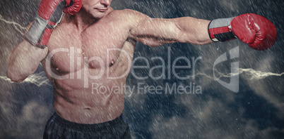 Composite image of bald boxer in fighting stance