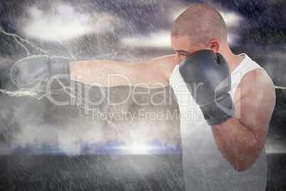 Composite image of side view of boxer hitting straight