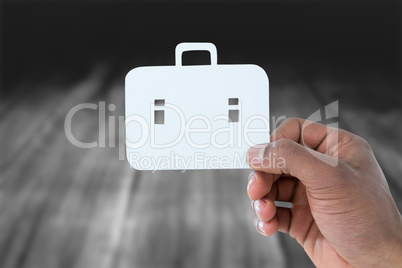 Composite image of hand holding a schoolbag