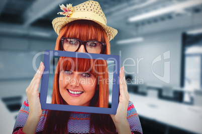 Composite image of attractive hipster woman behind a tablet