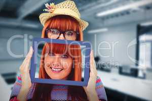 Composite image of attractive hipster woman behind a tablet