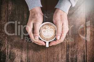 Cropped man holding white coffee cup