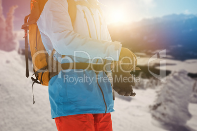 Composite image of midsection of skier wearing gloves