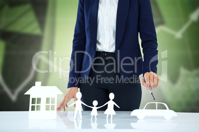 Composite image of woman drawing a car, a family and a house