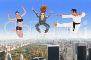 Composite image of man and women jumping over white background