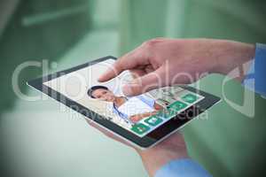 Composite image of croped hands of businessman using digital tablet