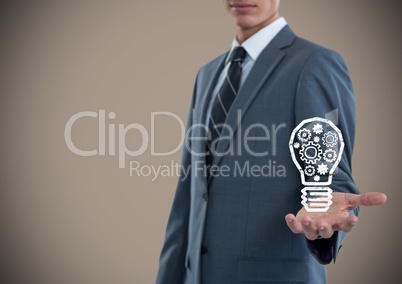 Business man hand out with lightbulb doodle against brown background