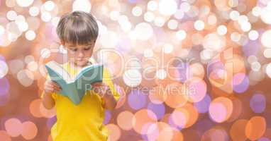 Girl reading book over bokeh