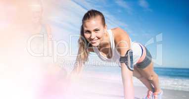 Smiling woman exercising at beach