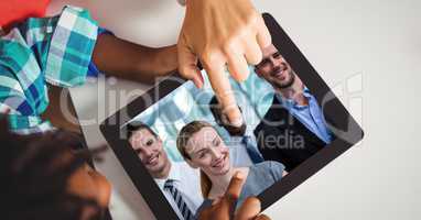 Hands touching tablet PC while video conferencing