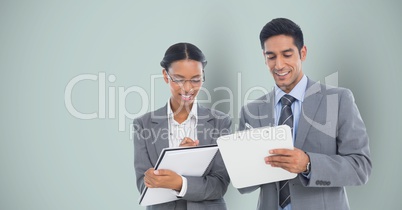 Business people writing against gray background