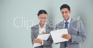 Business people writing against gray background