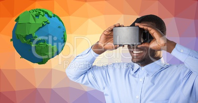 Businessman wearing VR glasses by low poly earth
