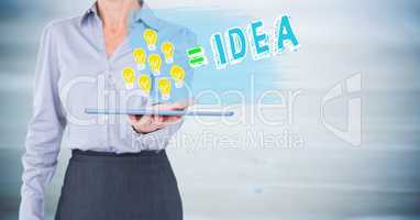 Business woman mid section with lightbulb doodles on tablet against blurry blue wood panel