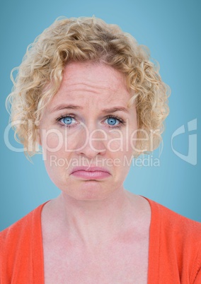 Woman pouting against blue background