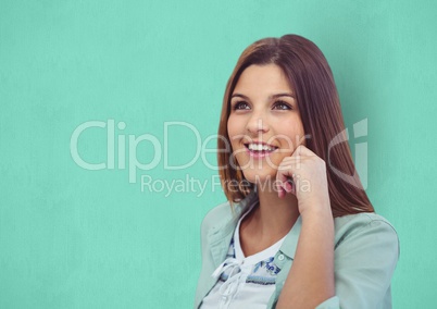 Thoughtful female hipster smiling against green background