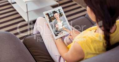 Woman video conferencing on tablet PC