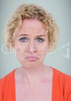 Woman pouting against light blue background