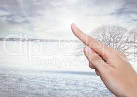 Hand pointing in  air of winter landscape