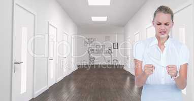 Angry woman looking at fists in hallway