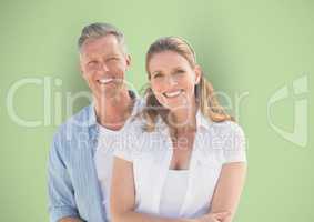 Portrait of happy couple against green background